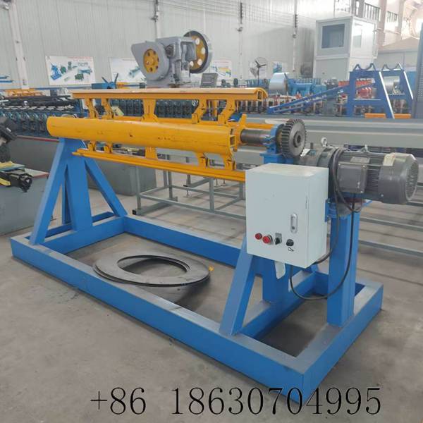 Electric decoiling machine front view showing complete uncoiler assembly with steel frame, motor-driven mandrel, and external control box for roll forming line coil feeding