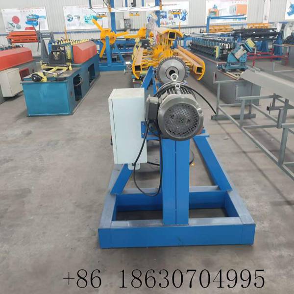 Decoiler side view showing the electric motor housing, chain-driven gear transmission, and welded steel frame structure of the coil unwinding machine