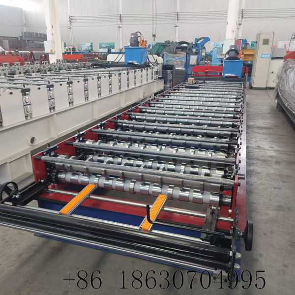 Machine feeding platform overhead view showing manual decoiler, coil feeding guide rails, and entry leveling station of the 1020 IBR roll former