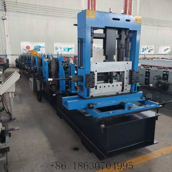 Front view of the fully automatic CZ purlin roll forming machine showing the hydraulic cutting unit and the forming stations behind it
